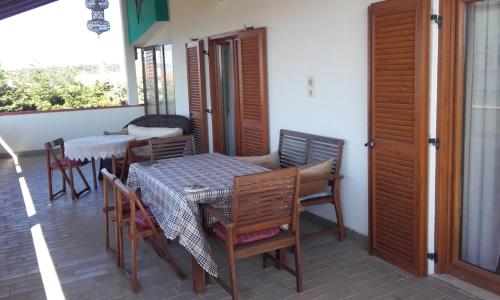 a patio with a table and chairs on a porch at Alba Apartments in Banjole