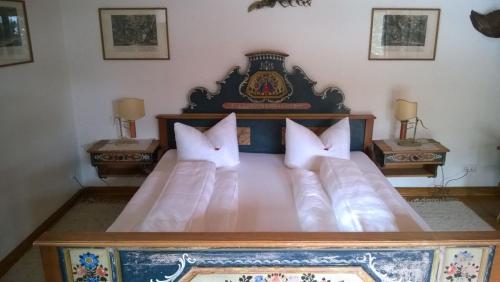 a large bed with white pillows in a bedroom at Jagdhaus Gerlos**** in Gerlos