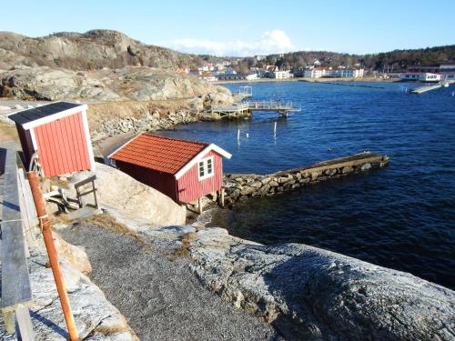 a small building on the side of a body of water at Sjöhuset in Ellös