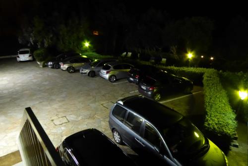a group of cars parked in a parking lot at night at Hotel Cyrnea in Bastia