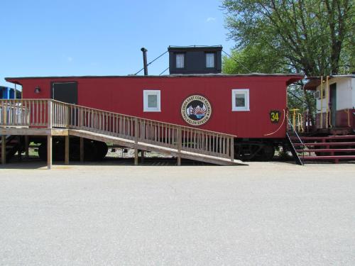 a red train car with a staircase next to it at Red Caboose Motel & Restaurant in Ronks