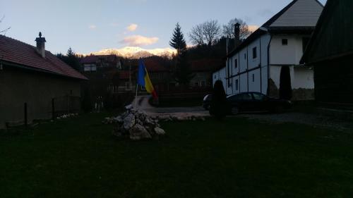 a car parked in a yard next to a house at Guest House Piatra Craiului in Bran