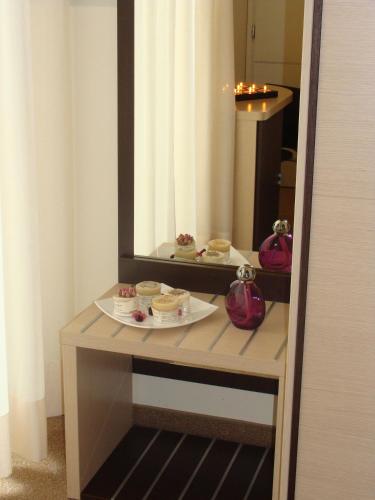 a table with a plate of food on a mirror at Hotel Daniel's FRONTE MARE in Riccione
