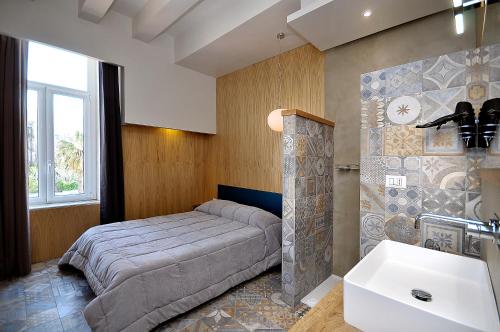 a bedroom with a bed and a sink at Villa Battista in Ercolano