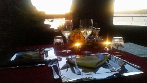 a table with wine glasses and a plate of food at Stella Maris Resort in Camogli
