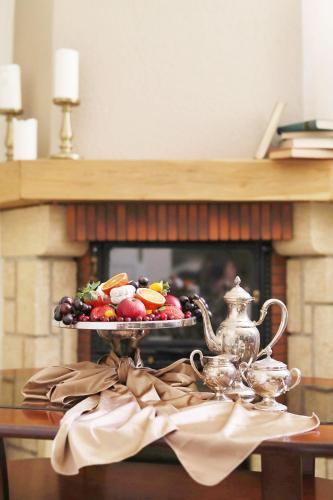 a tray of food on a table with a fireplace at Old Riga Boutique Hotel "Vecriga" in Rīga