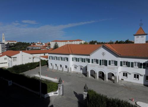 a large white building with a red roof at Hotel Irmãs Dominicanas - Fátima by Flagworld Hotels in Fátima