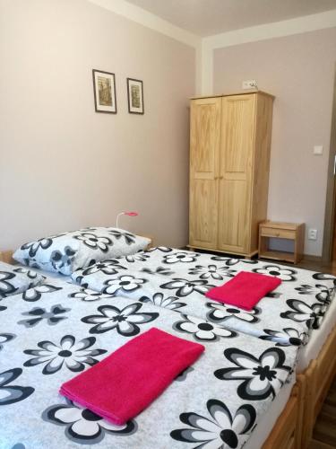 a bedroom with a bed with red towels on it at Ubytování u Kratochvílů in Dolní Dunajovice