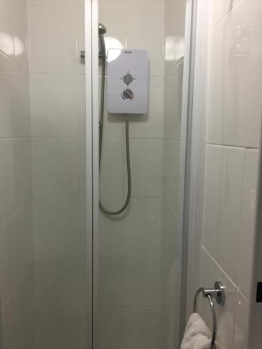 a shower in a bathroom with a shower at Trewinda Lodge in Newquay