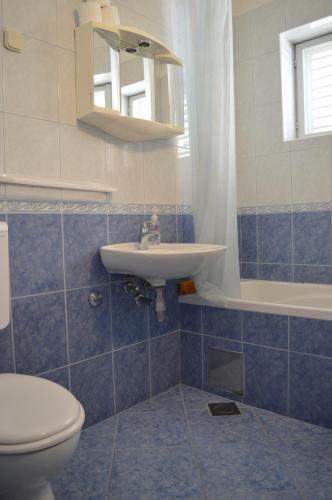 a bathroom with a sink and a toilet at Apartments Majstrovic in Živogošće