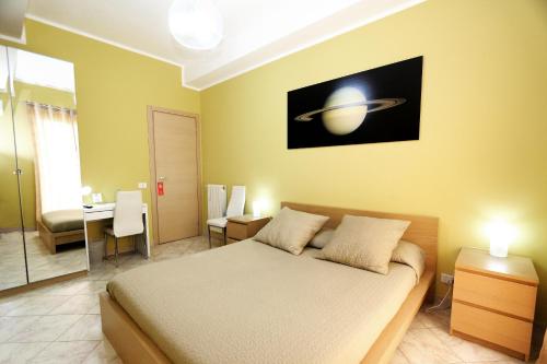 a bedroom with a bed and a small room with at Kosmos in Siracusa
