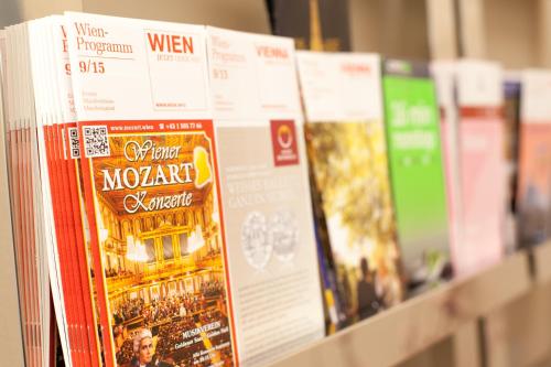 a row of books are lined up on a shelf at Sofie Apartments in Vienna