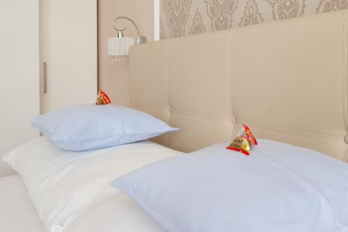 two white pillows sitting on top of a bed at Sofie Apartments in Vienna
