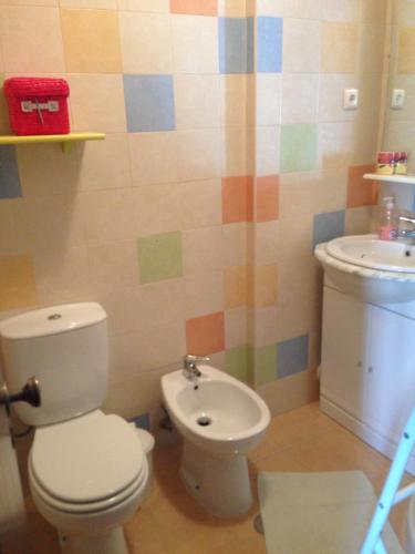 a bathroom with a toilet and a sink at SUN & SURF in Aljezur