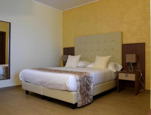 מיטה או מיטות בחדר ב-Hotel Residence Eden