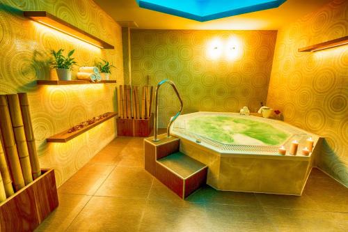 a large bathroom with a large tub in a room at Miraj Resort in Lučenec