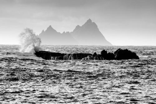a wave hitting a rock in the ocean at Quinlan & Cooke Boutique Townhouse and QCs Seafood Restaurant in Cahersiveen