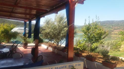a porch with a view of a river at Relais De Tahla in Ain Boumahdi