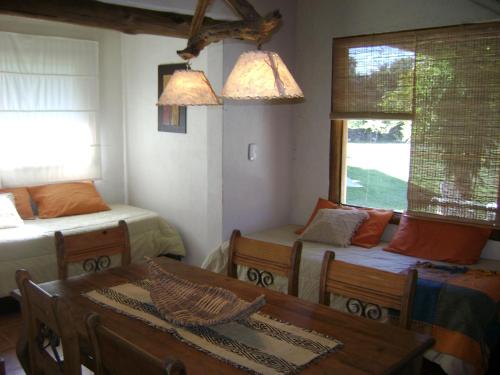 a room with a table and a bed and a couch at Cabañas La Curucucha in Nono