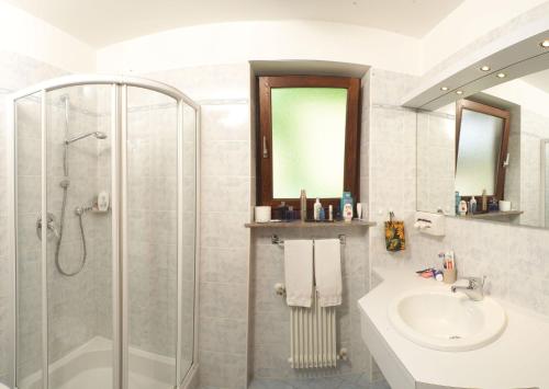 a bathroom with a shower and a sink at Hotel St. Justina Hof in Appiano sulla Strada del Vino