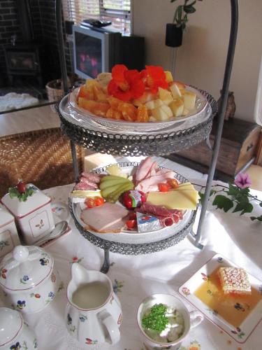 a plate of food on a table with a plate of food at Fernglen B&B in Auckland