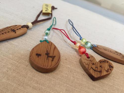 three wooden hearts are sitting on a table at Minshuku Satomachi in Yakushima