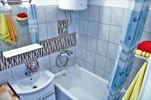 a bathroom with a bath tub and a sink at Soul Apartment in Center in Split