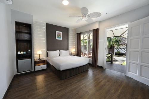 a bedroom with a bed and a ceiling fan at Perhentian Island Resort in Perhentian Island