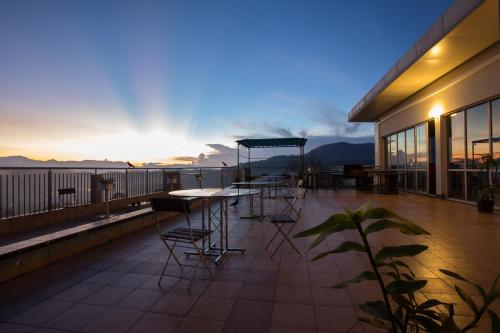 a patio with a table and chairs on a balcony at Hotel Topaz in Kandy