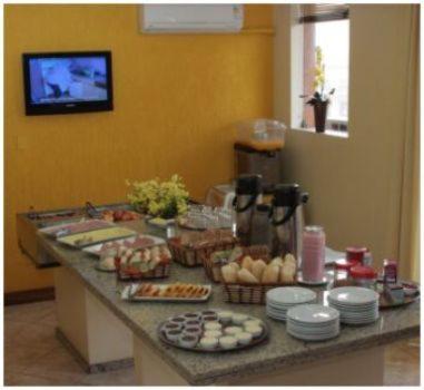 a kitchen with a counter with food on it at Hotel Scala in Porto Alegre