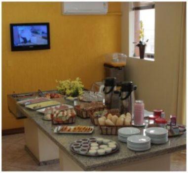 a buffet of food on a table at Hotel Scala in Porto Alegre
