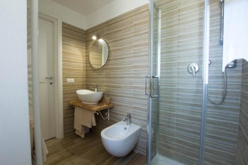 a bathroom with a sink and a glass shower at Masseria Poli Country House in Conversano
