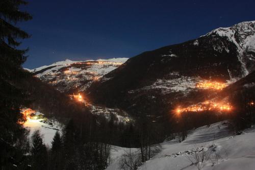 a view of a snowy mountain at night at Ferme Saint-Aubin in Sainte-Foy-Tarentaise