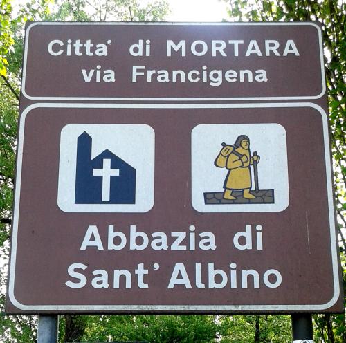 a sign in a foreign language with a woman on it at B&B Antica Corte Lombarda in Mortara
