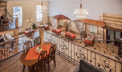 a restaurant with a balcony with a table and chairs at SanMari in Daugavpils