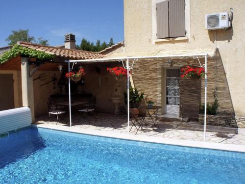 a house with a swimming pool next to a house at Charming holiday cottage with large private pool in Robion en Luberon