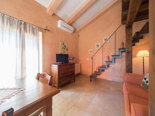 a living room with a staircase and a television at Farmhouse Montalto near Sandy Beaches in Montalto di Castro