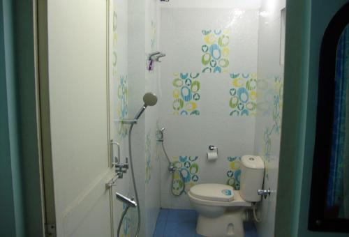 a bathroom with a toilet and a shower at The Port Vista in Port Blair