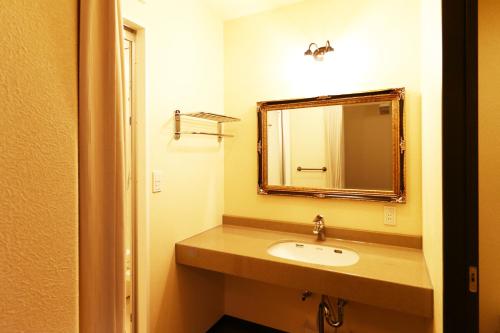 a bathroom with a sink and a mirror at Ryokan Karasawa in Kanazawa