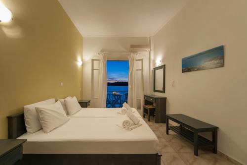 A bed or beds in a room at Angeliki Seaside Hotel