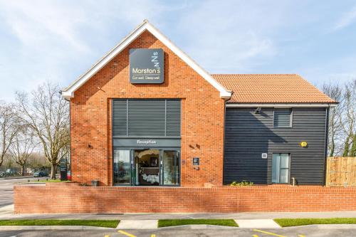a store front of a brick building with a window at Mermaid, Ipswich by Marston's Inns in Ipswich