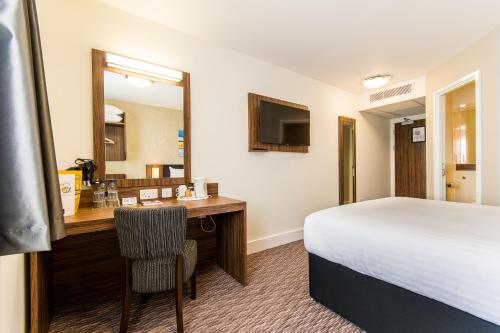 a hotel room with a bed and a bathroom at Mermaid, Ipswich by Marston's Inns in Ipswich