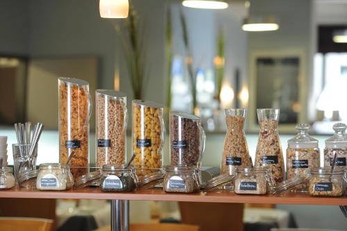 a shelf with many glass vases filled with food at Central-Classic Hotel in Stuttgart
