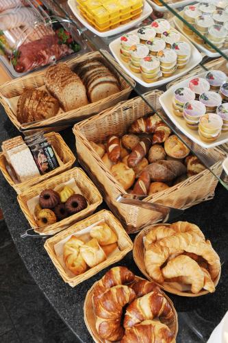 a bunch of different types of bread and pastries at Central-Classic Hotel in Stuttgart