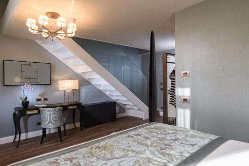 a bedroom with a staircase and a desk and a bed at Palazzo Veneziano - Venice Collection in Venice