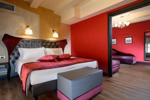 a bedroom with a large bed with red walls at Palazzo Veneziano - Venice Collection in Venice