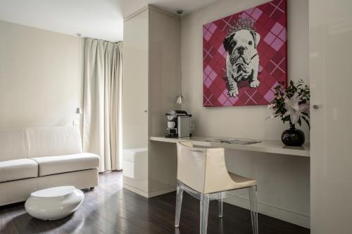 a living room with a dog painting on the wall at Le Quartier Bercy-Square in Paris