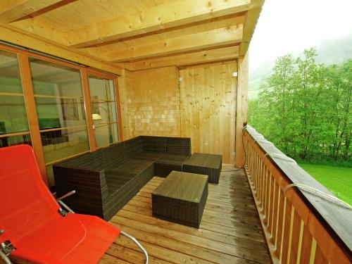 a porch with a couch and a bench on a deck at Apartment at the ski lift in Brand in Vorarlberg in Brand