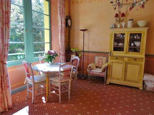 a dining room with a table and chairs at Two Studios with pool in garden Park nearby spas and views at the Mont Ventoux in Montbrun-les-Bains