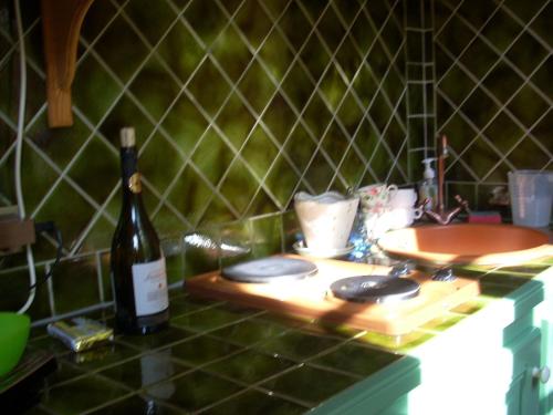 a bottle of wine sitting on a counter next to a sink at Château Luxury Stay Montbrun in Montbrun-les-Bains